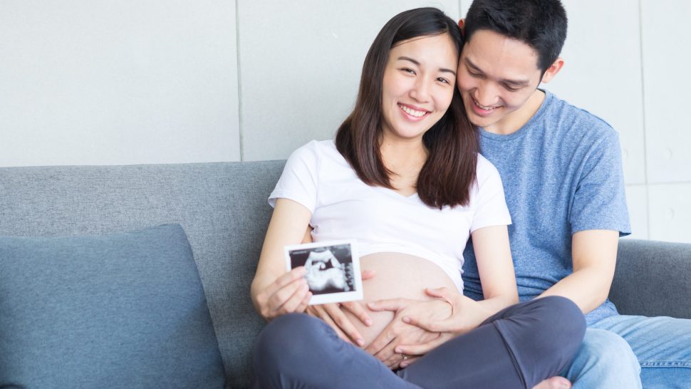 Women and men are showing love and showing ultrasound images of their fetuses. Dad and mom.