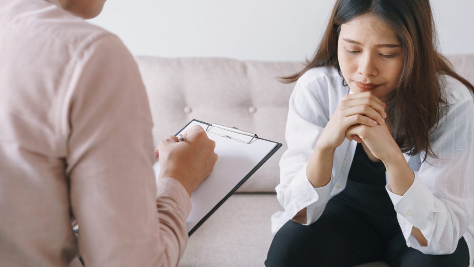 women Asian patients with man psychologist examination consulting and In psychotherapy by the physician in the clinic. psychiatrist concept