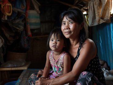 Realistic photograph of a mother and her daughter sitting together, their expressions wistful and dreamy, as they imagine a beautiful house. The image captures a tender moment between them, surrounded by a modest, perhaps cramped living space that contrasts sharply with their dream. The setting suggests a longing for better living conditions, with subtle details in the background hinting at their current struggles. This scene conveys hope and aspiration, despite challenging circumstances. Analog style, 35mm, high quality and detail. --ar 3:2 --v 6 Job ID: 0ba3e592-43b4-4fe4-8315-555e7dc5a453