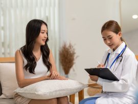 Asian doctor woman visited patient woman to diagnosis and check up health at home or private hospital. Female patient explain health problem and symptoms to doctor .Health care premium service at home