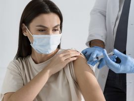 brunette-woman-being-vaccinated-by-doctor