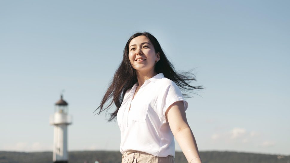 low-angle-smiley-woman-posing