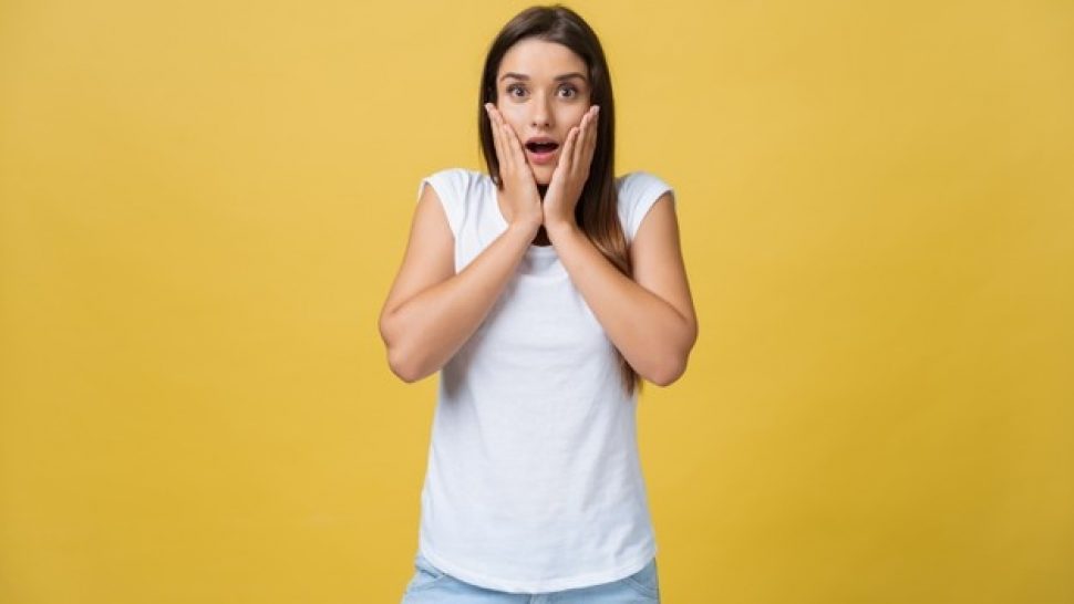 surprised-teenage-girl-show-shocking-expression-with-something-isolated-bright-yellow-background-copy-space_1258-80700
