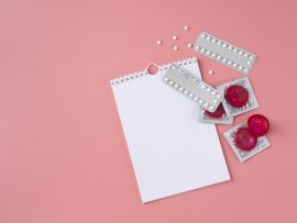 top-view-red-condoms-pills-arrangement