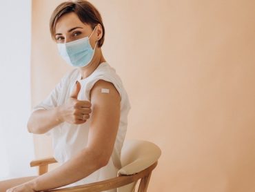 woman-with-plaster-shoulder-sitting-chair-after-vaccination_1303-28448