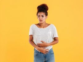 young-woman-holding-her-stomach-isolated_171337-6624